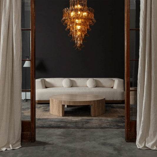 Amber Petalo Glass Chandelier glowing in a dark dining lounge viewed through wood doorways