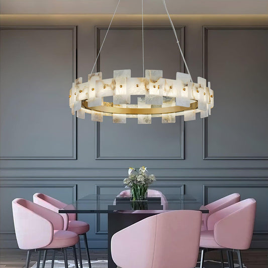Alabaster Halo Chandelier centered above a dark living room sofa