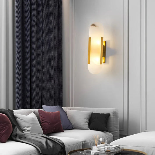 Contemporary Alabaster Wall Lamp glowing above a sofa in a paneled living room