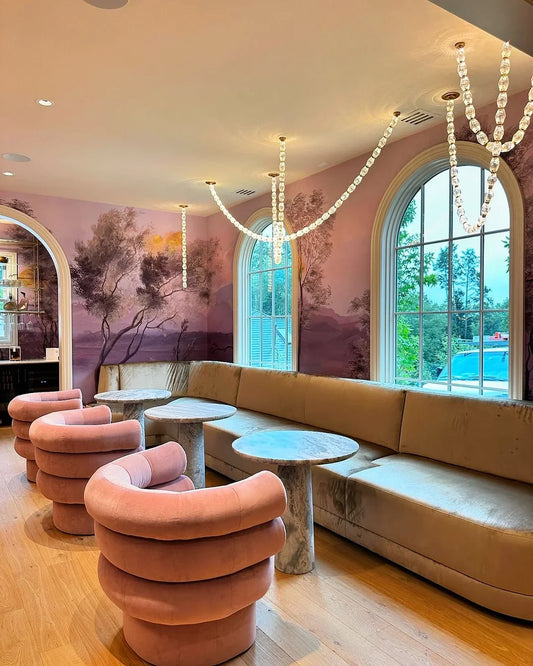 Creative Glass Pearl Necklace Chandelier installed as luminous loops in a colorful lounge