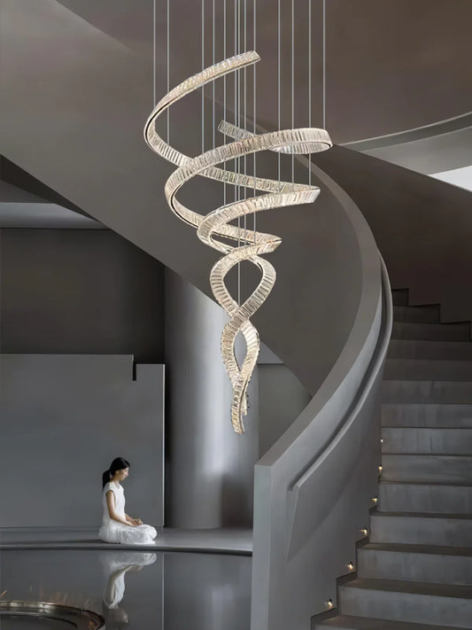 Loong Spiral Crystal Chandelier installed beside a curved staircase with visible upper landing