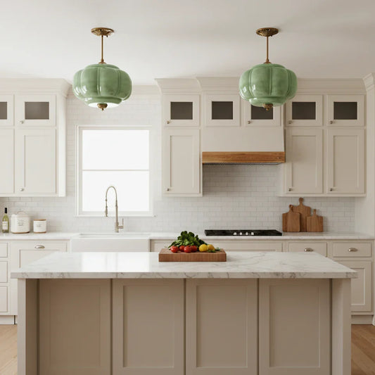 Two green ribbed glass pendants above a white kitchen island