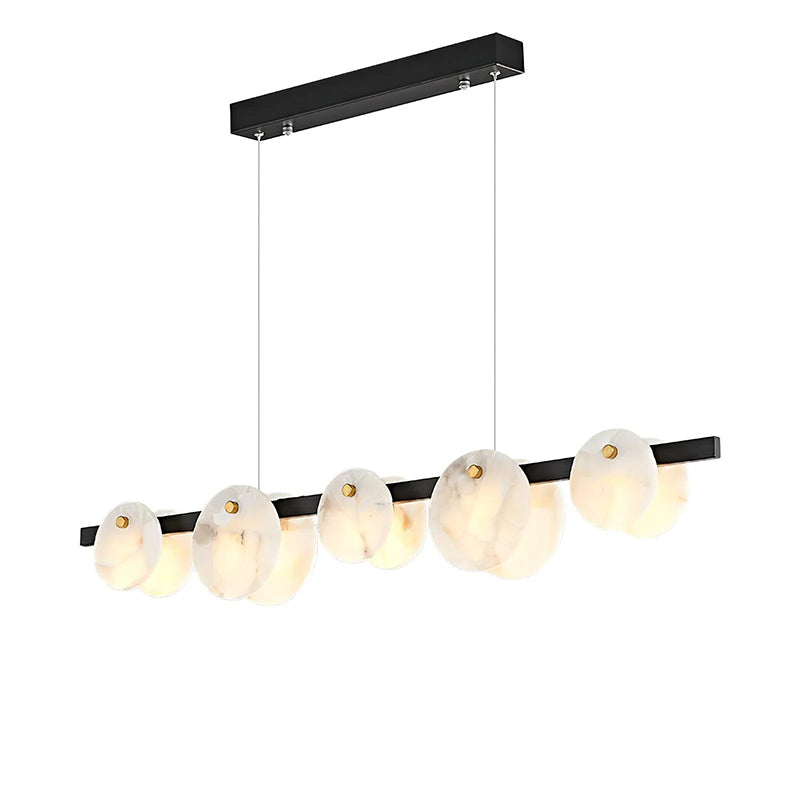 Warm alabaster chandelier above a dining area