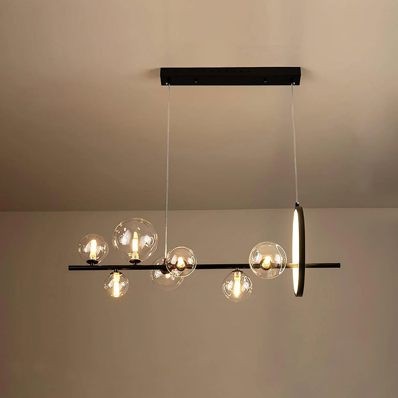 Modern linear glass globe chandelier over a dining table